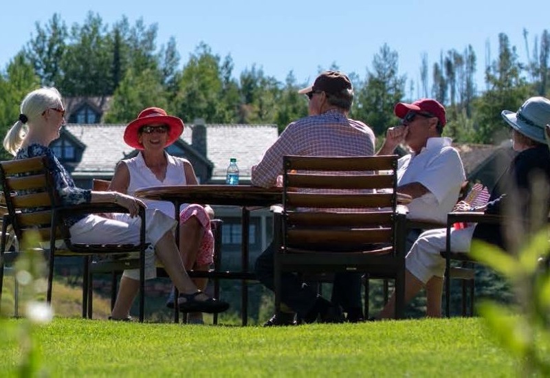 Group of people sitting around a table socializing